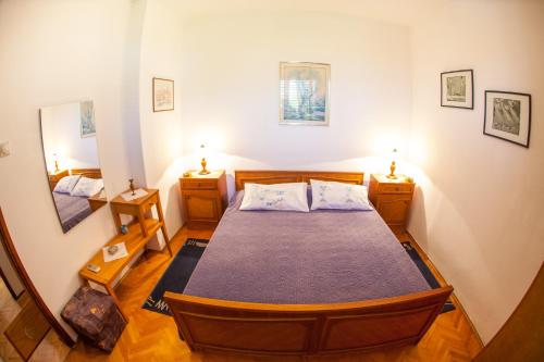 a bedroom with a bed and two night stands at Azur Apartment in Budva