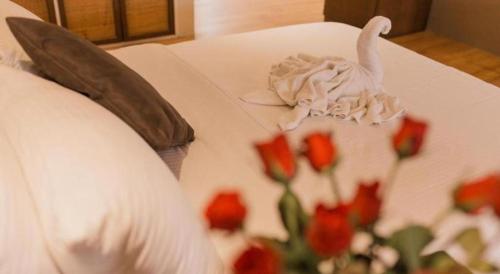 a cake with a swan on a table with flowers at Kingsleys Hotel and Gastro Pub in Angeles