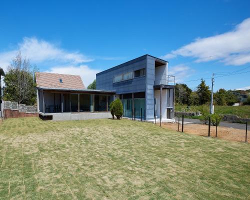 a house with a large yard in front of it at Date Villa Awaji in Sumoto