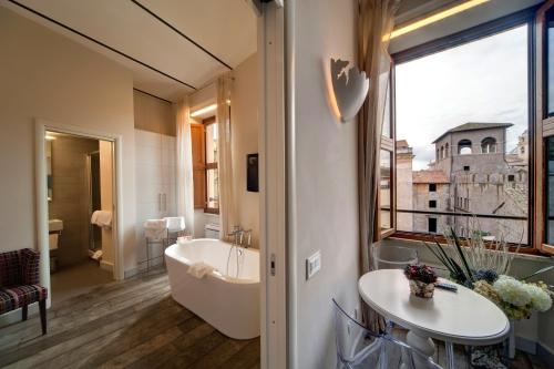 łazienka z wanną, umywalką i oknem w obiekcie Navona Palace Luxury Inn w Rzymie