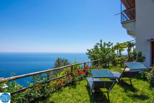 a balcony with two chairs and a view of the ocean at Villa Antica Macina in Positano