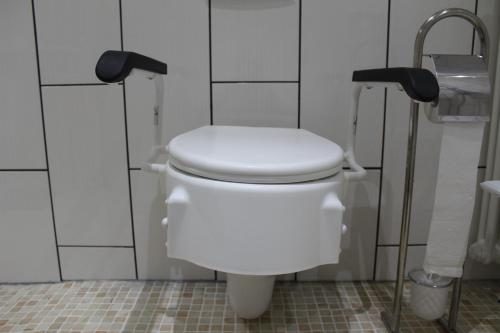 a bathroom with a white toilet in a stall at Gästehaus Mama in Rust