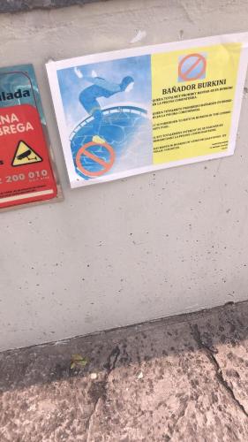 two signs on the side of a wall at Paradise Village Port Aventuras in Salou