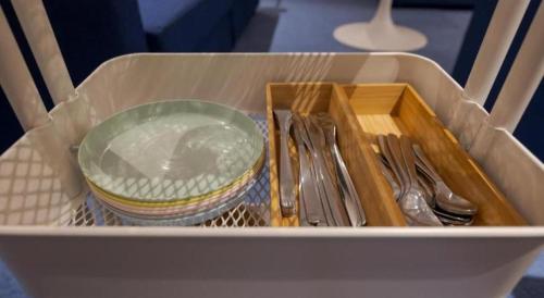 a container with utensils and a bowl and a plate at CS Premier Hotel in Seoul