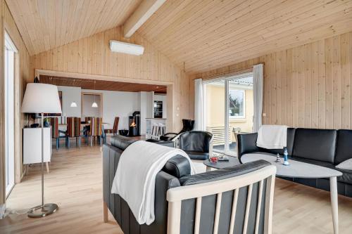 a living room with a couch and a table at Lovely Holiday Home With Fenced Plot, 300 Meters From The North Sea In Thy in Lild Strand