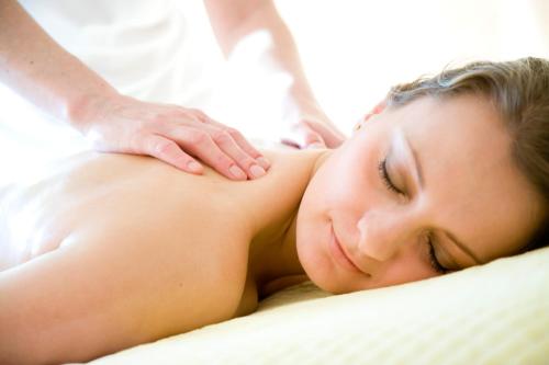 a woman getting a massage from a therapist at Hotel Seefischer - Finest Hideaway in Döbriach