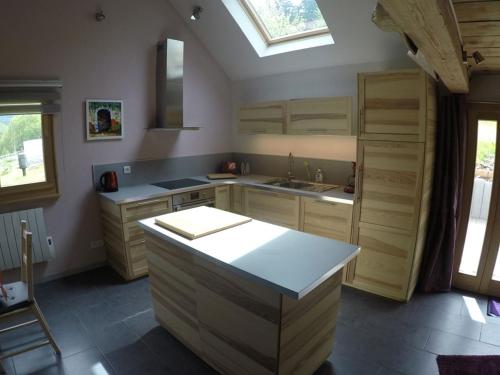 a kitchen with wooden cabinets and a skylight at La Grange in Lautenbachzell