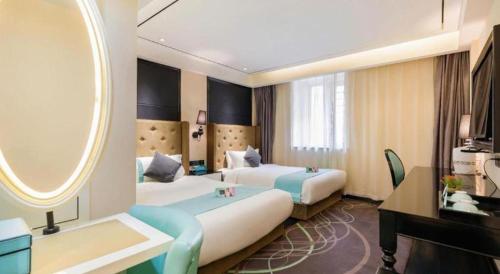 a hotel room with two beds and a tub at Xana Hotelle· Tianjin Railway Station Jinwan Square Binjiang Avenue in Tianjin