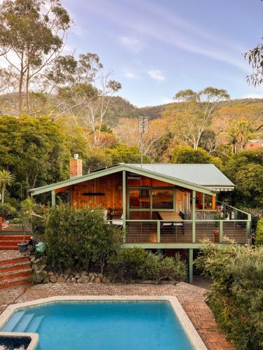 a house with a swimming pool in front of it at Bush Retreat on the Bay in McCrae