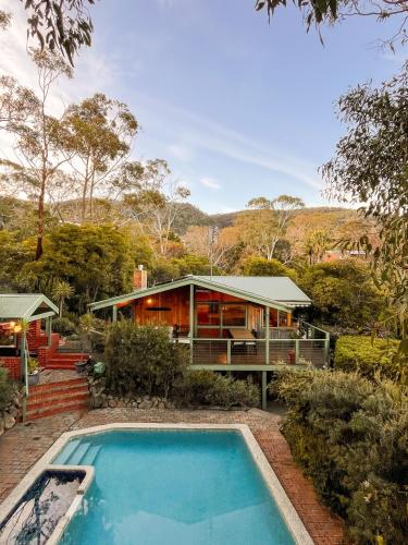 a house with a swimming pool in front of it at Bush Retreat on the Bay in McCrae