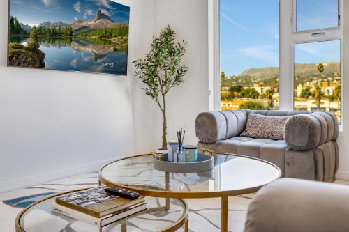 a living room with a couch and a glass table at One Lux Stay - Hollywood in Los Angeles