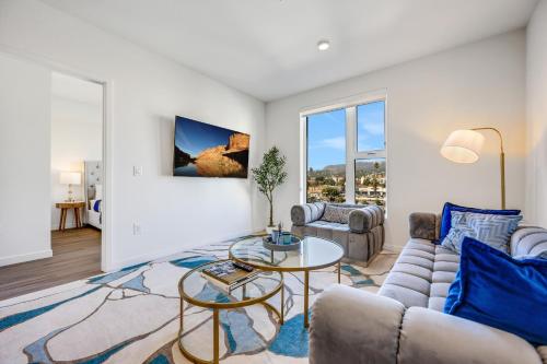a living room with a couch and a table at One Lux Stay - Hollywood in Los Angeles
