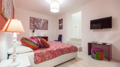 a bedroom with a bed and a flat screen tv at Rental in Rome Palermo apartment in Rome