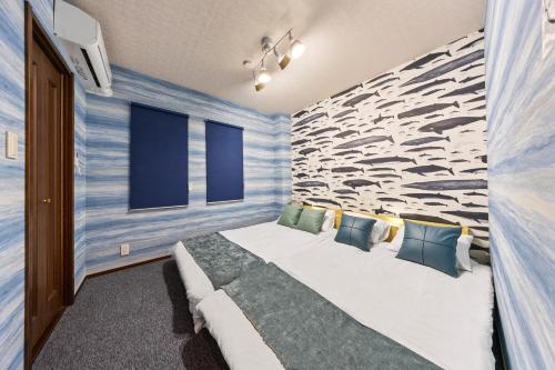 a bedroom with a large bed with a stone wall at 一棟貸しの親子で遊べる貸し切りアパート国立駅徒歩4分 in Kunitachi