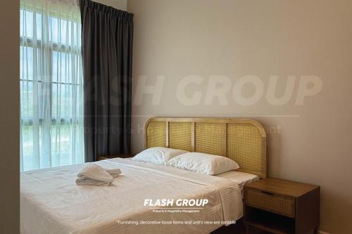 a bedroom with a bed with white sheets and a window at Enclave Nature Suites @ Bukit Tinggi in Bentong