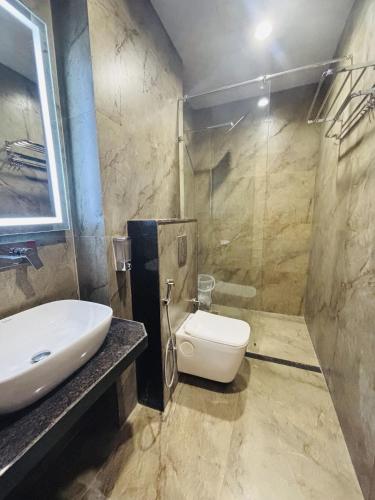 a bathroom with a sink and a toilet at Hotel Royal Nest in Ajmer