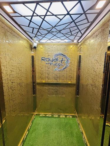 a room with a green floor and a sign on the wall at Hotel Royal Nest in Ajmer