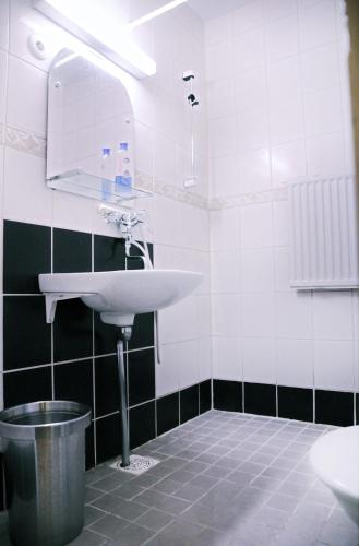 a bathroom with a sink and a mirror at Hotel Lamminpää in Tampere
