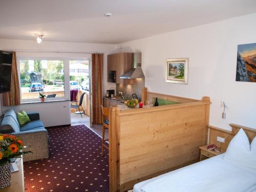 a hotel room with a bed and a kitchen at Appartements Stadlerhof in Kramsach