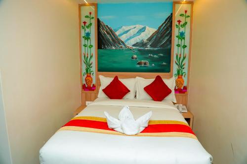 a bedroom with a bed with a painting on the wall at Hotel Kedarnath in Kathmandu