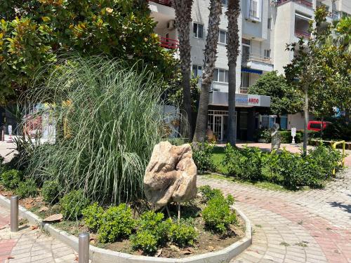 a large rock in a garden in a city at HOTEL Apartments ARDO in Golem