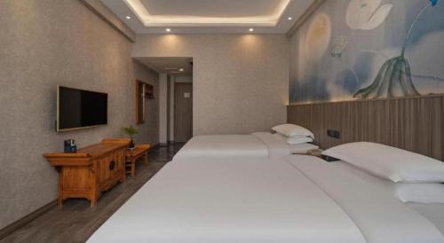 Un ou plusieurs lits dans un hébergement de l'établissement Xi'an Huiya Tianmu Hotel