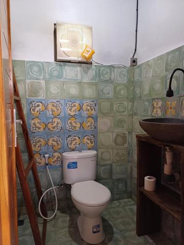a bathroom with a toilet and a sink at Villa Esa Bagus - Volcano view - big pool in Tampaksiring
