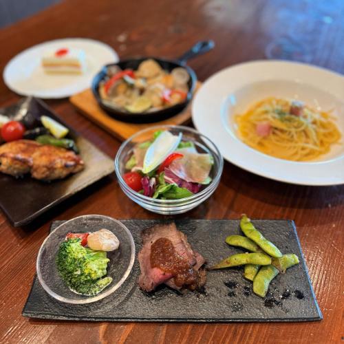 a table with plates of food and a bowl of soup at ペンションニライカナイ NiraiKanai in Awaren