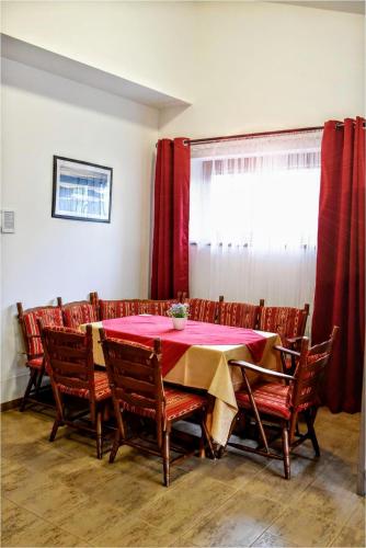 a dining room with a red table and chairs at Low cost ProPřespání Kouty nad Desnou in Loučná nad Desnou