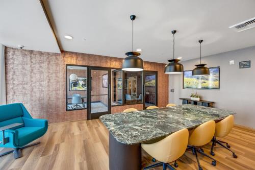 a dining room with a large marble table and chairs at One Lux Stay - Hollywood in Los Angeles