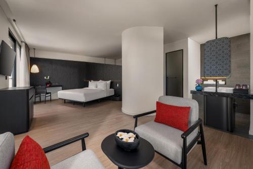 a hotel room with a bed and a living room at Caro Premium Danang Hotel in Da Nang