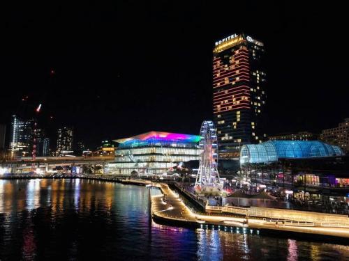 a city lit up at night with a river and buildings at Convenient 2BR Nest in Liverpool - Stay with Ease in Liverpool