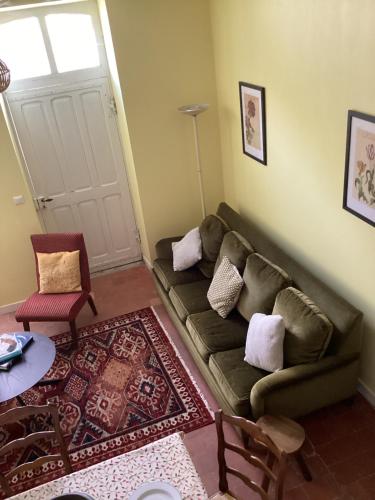 a living room with a couch and a table at Rural House near Sancerre 2 bedrooms in Feux