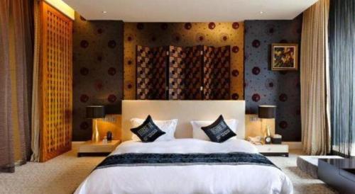 a bedroom with a large white bed with two pillows at Putian Depo Hotel in Putian
