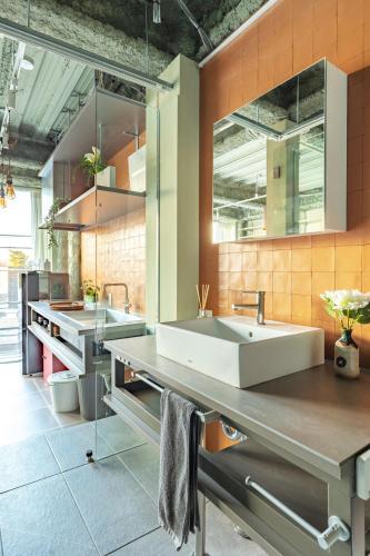 a large kitchen with two sinks and orange tiles at TOKYO Beverly Hills,Exclusive Lifestayle,SHIUYA,SHINJUKU,ART,Bespoke ApartmentSEIJO in Waizumi