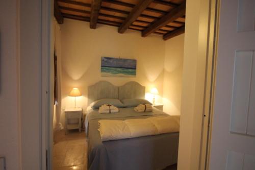 a bedroom with a bed with two pillows on it at Il Borgo Trapanese in Trapani