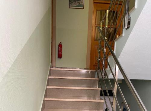 a stairway with a red fire hydrant in a building at Villa Apartments Babaja in Omiš