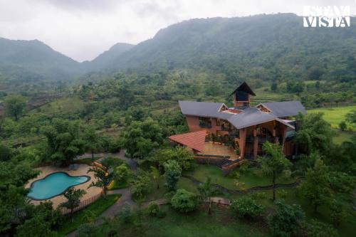 an aerial view of a house in a mountain at StayVista at Pranah in Karjat