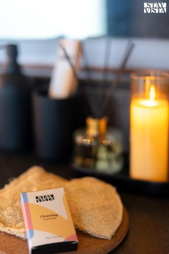a piece of bread and a candle and a card on a table at StayVista at Pranah in Karjat