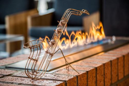 two copper wire sculptures in front of a fireplace at City Lodge Newtown, Johannesburg in Johannesburg