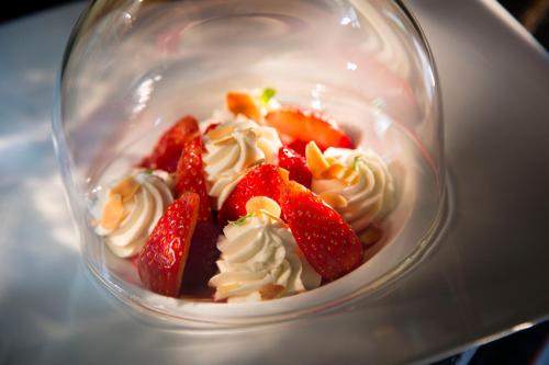 a dessert with strawberries and whipped cream in a glass bowl at Hotel De France in Angerville