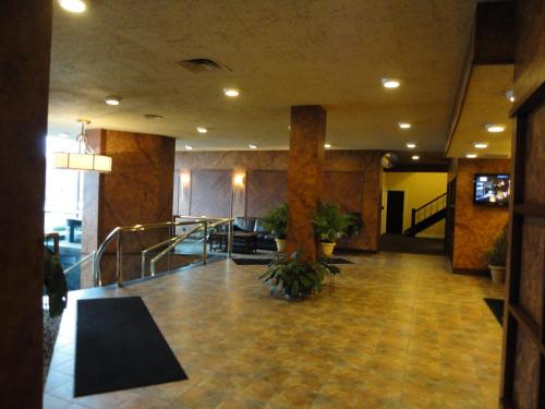 a lobby with a staircase in a building at Lenox Hotel and Suites in Buffalo