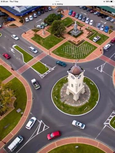 arial view of a parking lot with a clock tower at Park View 'Home Away From Home' in Feilding