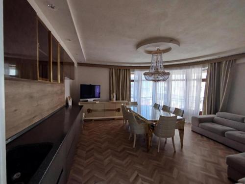 a living room with a table and a dining room at Baku Artpatena Lake view in Baku