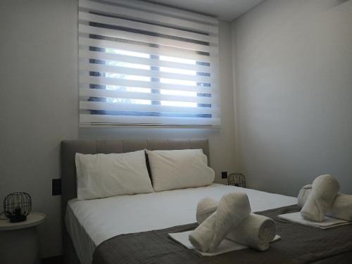 a bedroom with a bed with towels on it at Kyvos in Keramotí