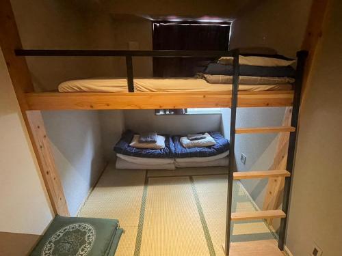 two bunk beds in a small room at Sakae Guesthouse in Nagoya