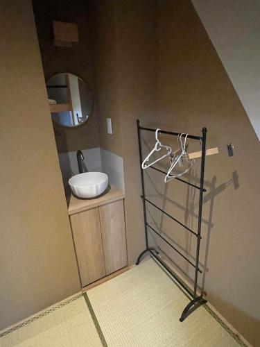 a bathroom with a sink and a mirror at Sakae Guesthouse in Nagoya