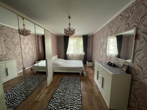 a small bedroom with a bed and a mirror at 2-х комнатная квартира in Aktobe