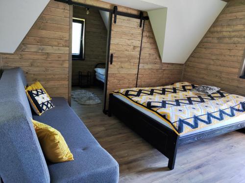 a bedroom with a bed and a couch at Chata Bosorečka in Smižany