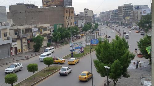a busy city street filled with cars and buildings at Dijlat Al Khair Hotel فندق دجلة الخير in Baghdad